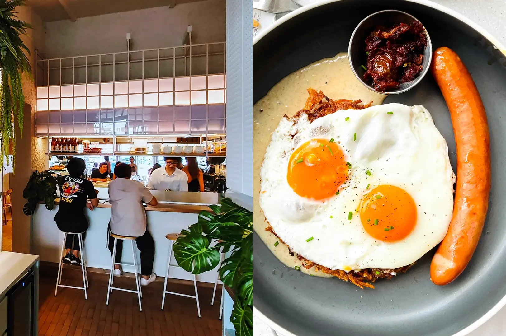 Left: Wide-angle, eye-level shot of a bright café counter with patrons seated on white stools, a visible open kitchen behind a tiled half-wall, indoor plants along the edges, and daylight filtering through large glass panels. Right: Top-down food shot of a dark round plate holding two sunny-side-up eggs with bright orange yolks, a long grilled sausage, a small metal cup of thick red relish, and a creamy sauce beneath the eggs, arranged with clean spacing and minimal garnish.