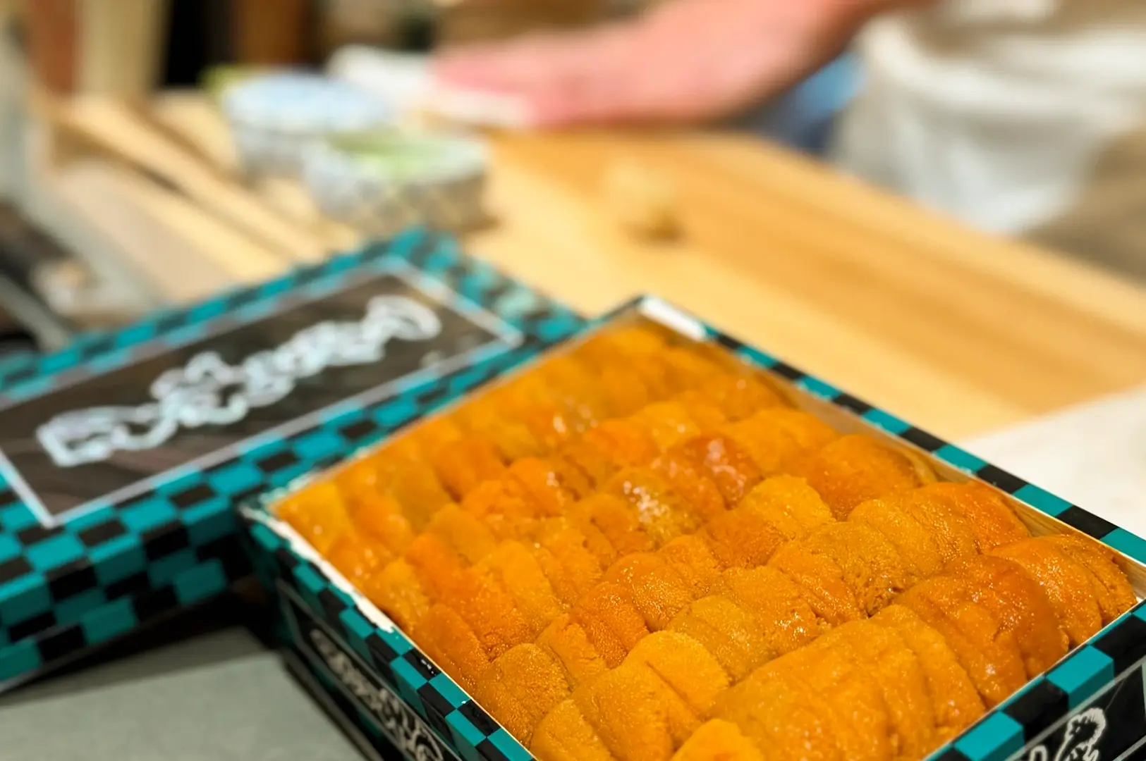 Close-up macro shot of fresh uni sea urchin at Sushi Muni Singapore, highlighting premium omakase ingredient and vibrant texture